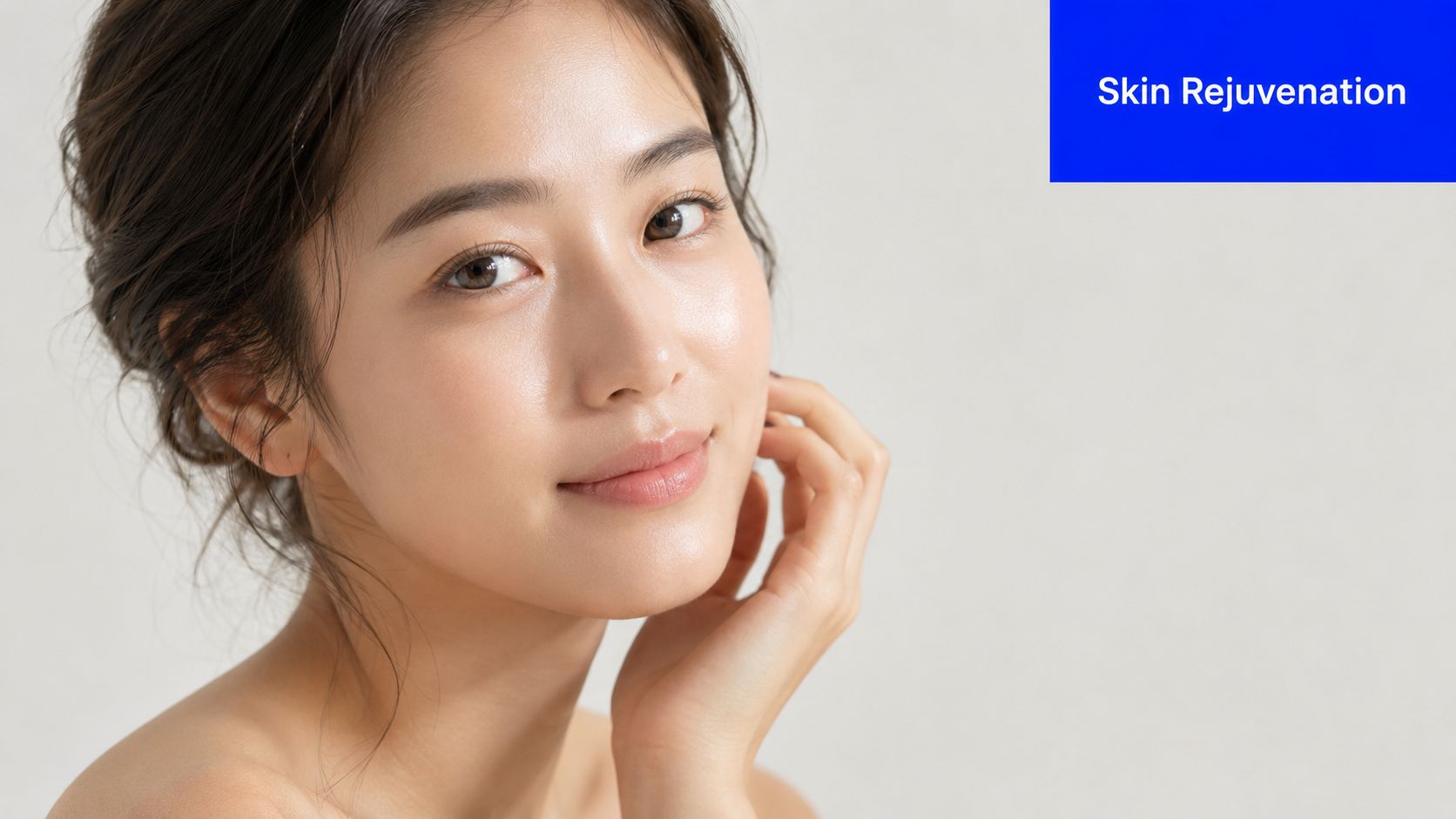 A young woman with smooth, radiant skin touching her face, representing dermatological skin rejuvenation and beauty.